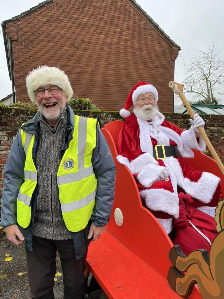 Santa with a man in a high-vis laughing at him